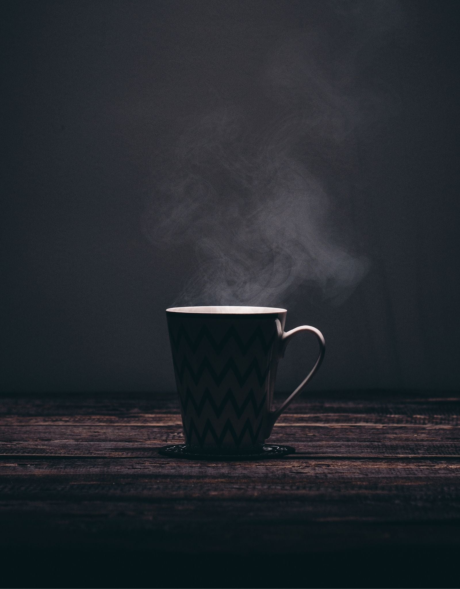 hot coffee in a mug on black background