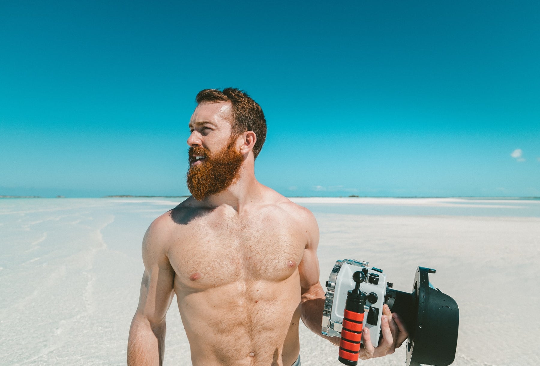 fit, bearded man on a beach